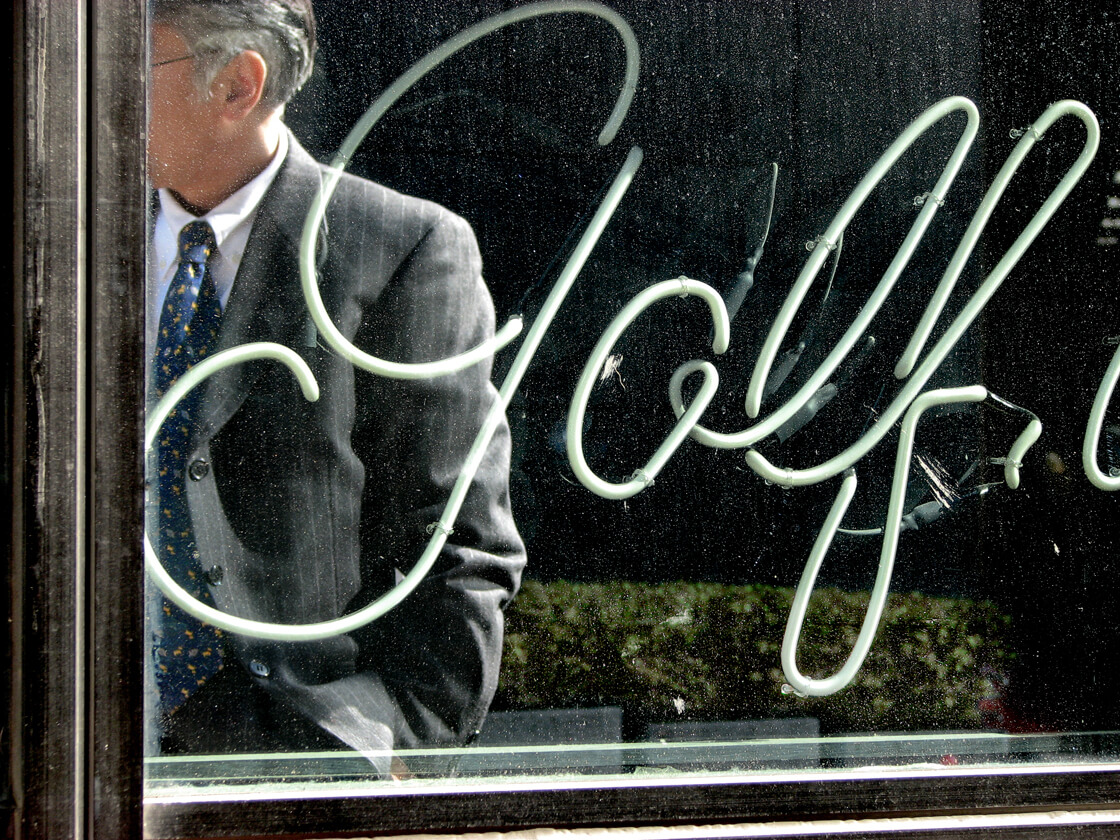 the refection of a salaryman in a golf accessory shop