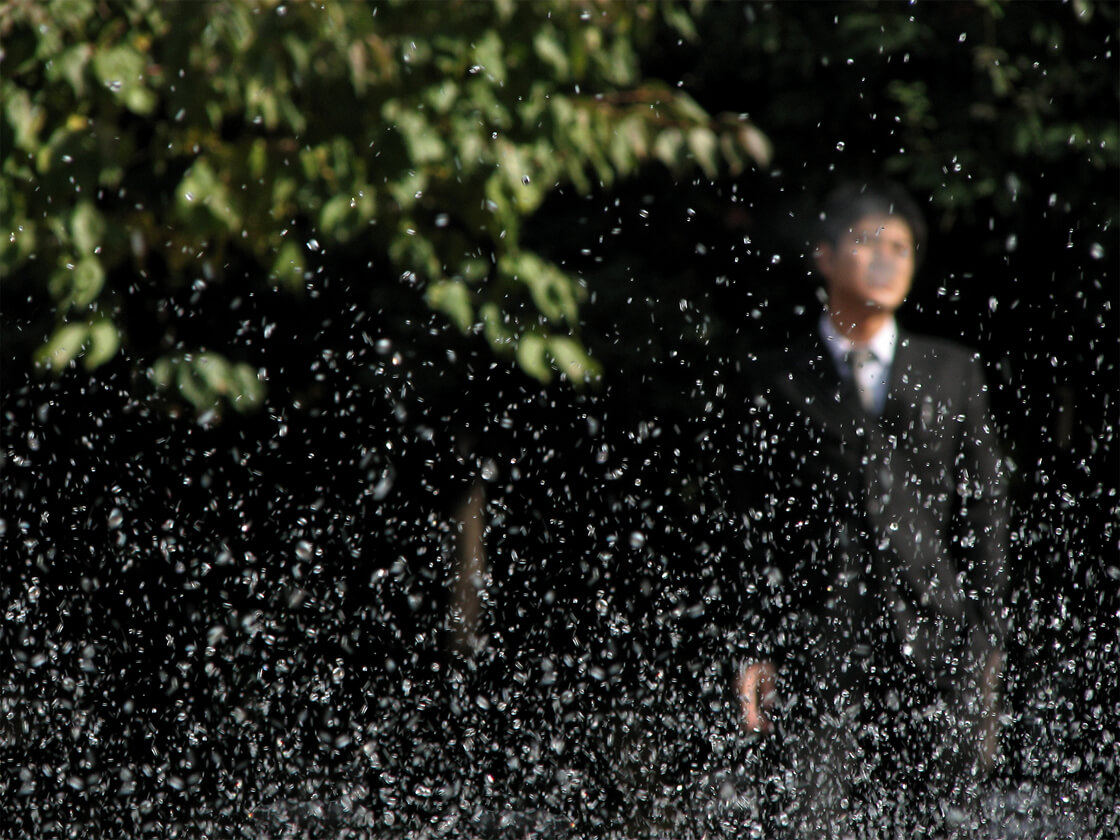 a salaryman near a fountain in Hibiya Park